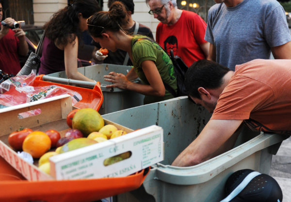 people looking through trash to prevent food waste